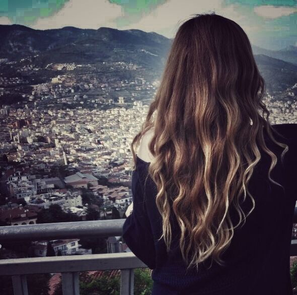 long hair, person, mountain, rear view, cityscape, standing, tourist, city, blond hair, straight hair, redhead, looking at view, medium-length hair, human hair, mountain range, tourism