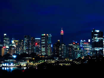 Illuminated buildings against sky at night