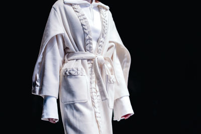 Fashion details of white long padded cardigan coat with belt, creative casual wear