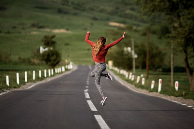 Woman jumping on road