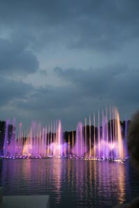 Reflection of illuminated buildings in water at night