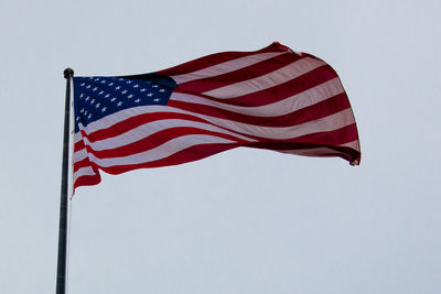 Low angle view of american flag against clear sky