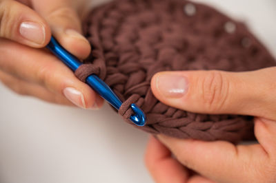 Close-up of hand holding sewing needle