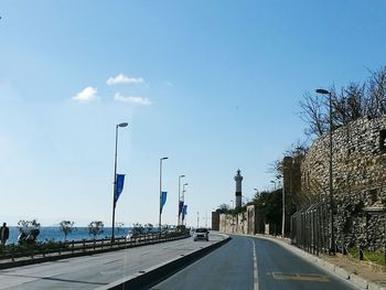 Road amidst trees against sky