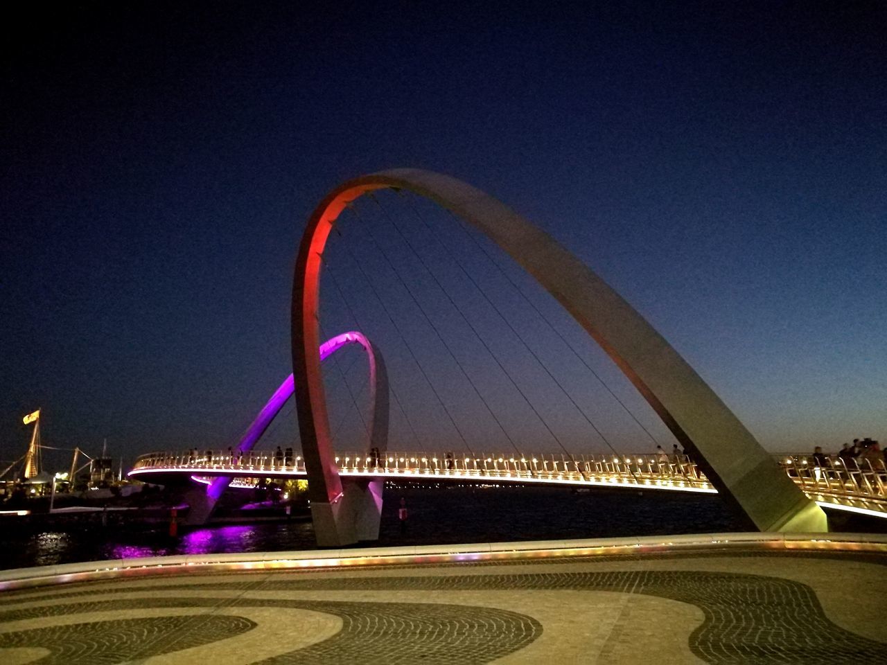 city, night, travel destinations, architecture, illuminated, bridge - man made structure, outdoors, no people, building exterior, clear sky, cityscape, built structure, ferris wheel, suspension bridge, sky