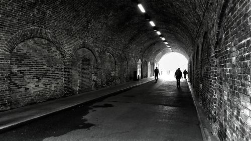 Rear view of woman walking in corridor