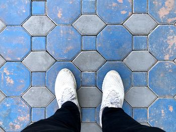 Low section of man standing on footpath