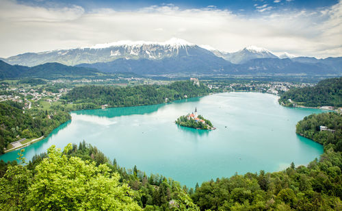 High angle view of lake and mountains against sky