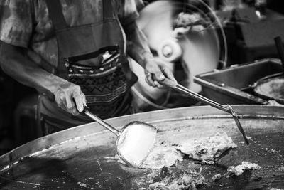 Midsection of man preparing food