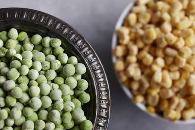 Green peas and corn in bowls