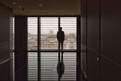 Rear view of silhouette man walking in corridor