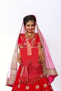 Woman holding red umbrella against white background