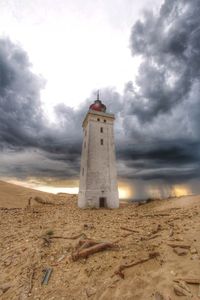 Lighthouse against cloudy sky