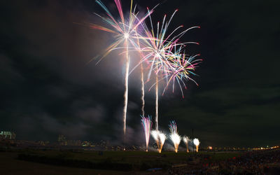 Low angle view of firework display at night