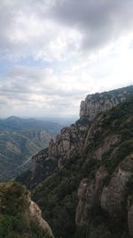 View of cityscape against cloudy sky