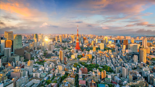 Aerial view of modern buildings against sky during sunset