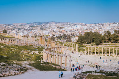 The oval forum of the jerash archaeological site with the new part of the city in the background