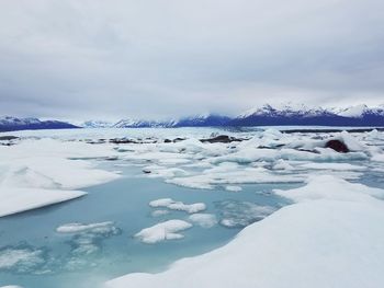 Scenic view of frozen lake against sky