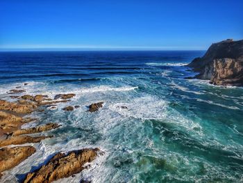 Scenic view of sea against clear blue sky