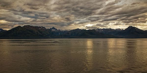 Scenic view of lake and mountains against sky