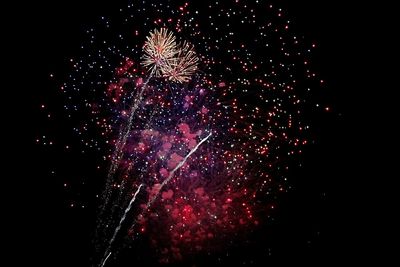 Low angle view of firework display at night