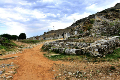 View of archaeological site against cloudy sky
