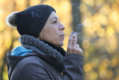 Close-up of woman holding ice cream outdoors