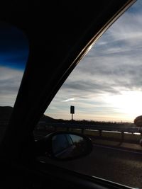 Bridge seen through car windshield at sunset