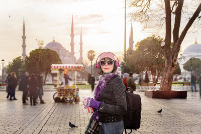 Side view of woman standing against hagia sophia museum