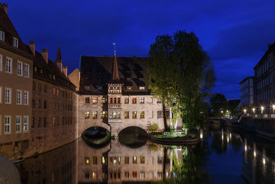 Reflection of buildings in city at night