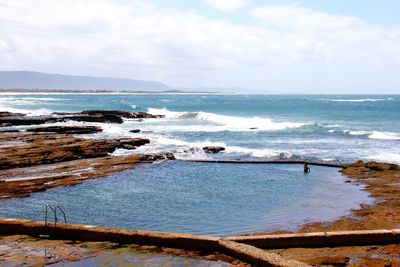 Scenic view of sea against cloudy sky