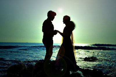 Rear view of woman standing on beach