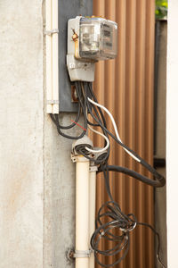 Close-up of electric lamp against wall