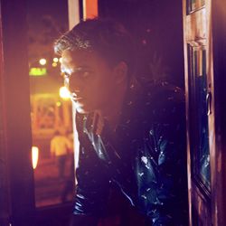 Side view of young woman looking at restaurant