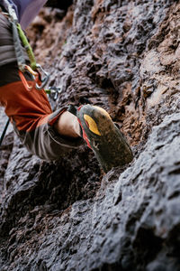 Low section of man standing on rock