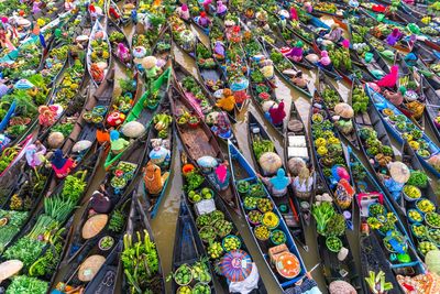 High angle view of vendors in boat on floating market