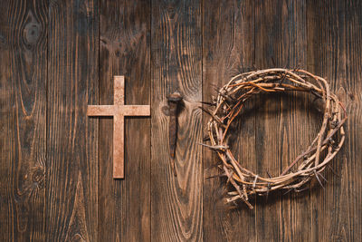 Jesus crown thorns and nails and cross on a wood background. easter day