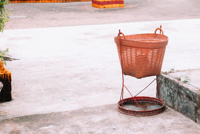 Brown waste basket on concrete