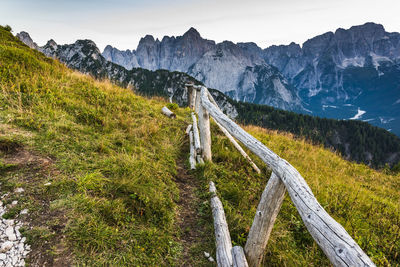 Scenic view of land and mountains against sky