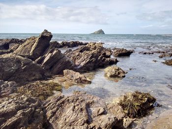 View of rocky beach against the sky