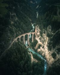 Arch bridge over river against mountains