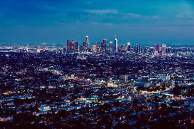 High angle view of illuminated city buildings against sky