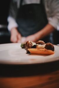 Close-up of chef preparing food on table