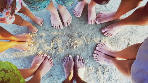 Low section of family standing at beach