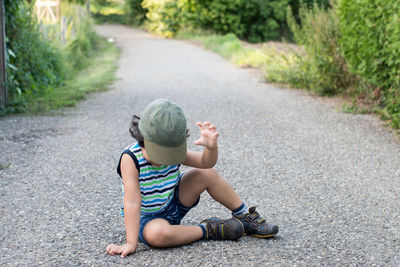 Boy sitting on road