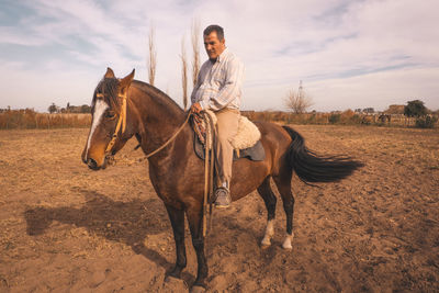 Man riding horse in rural area