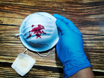 High angle view of hand holding ice cream on table