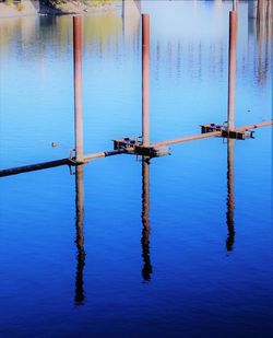 Wooden post in lake