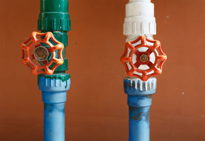 Close-up of multi colored water pipe against wall
