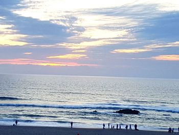 Scenic view of beach against sky during sunset